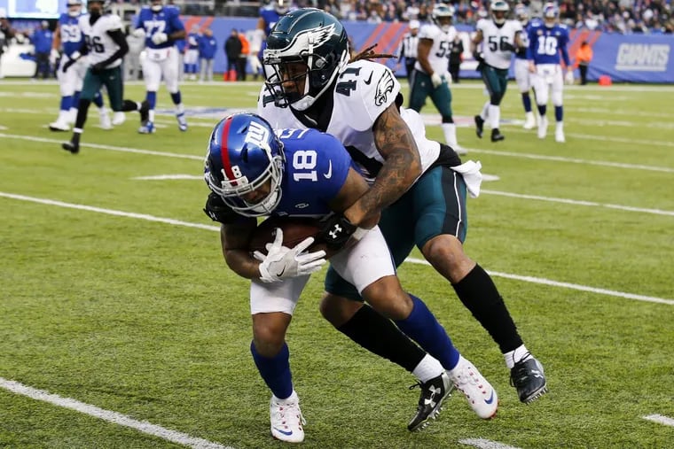 Philadelphia Eagles cornerback Ronald Darby stops New York Giants wide receiver Roger Lewis during Sunday’s game at MetLife Stadium.