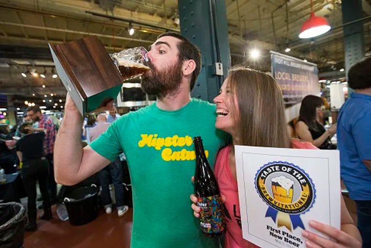Chuck Golder, at the Inquirer's 2018 Brewvitational at Reading Terminal Market with Jacey Royer, celebrates La Cabra's Best New Beer win by drinking out of the trophy. La Cabra says someone has stolen the trophy from their Berwyn brewpub.