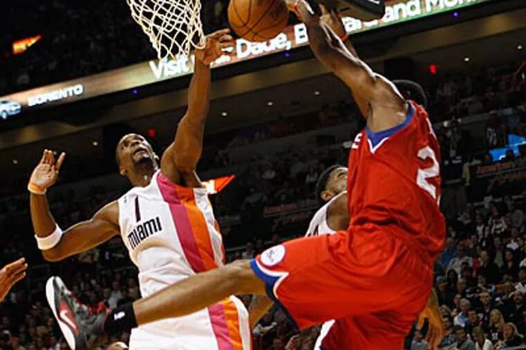 The Heat's Chris Bosh blocks Thaddeus Young in the second half on Saturday night. (Lynne Sladky/AP)