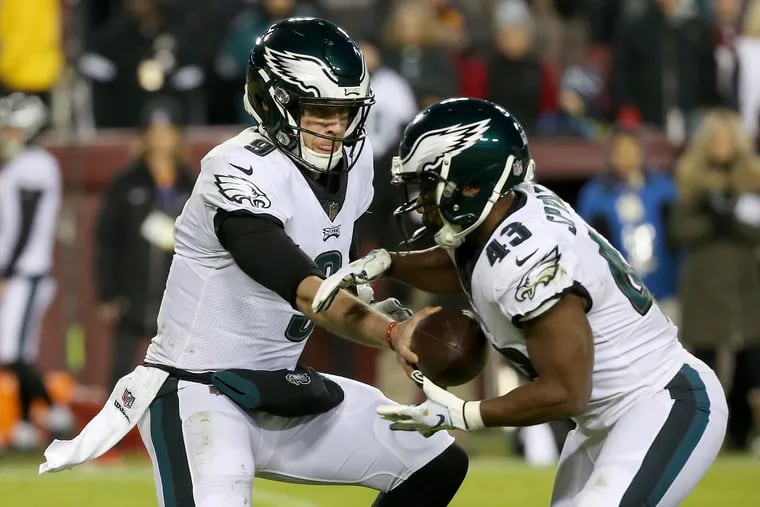 Eagles quarterback Nick Foles (9) hands the ball off to running back Darren Sproles (43) during a game against the Washington Redskins at FedEx Field in Landover, Md., on Sunday, Dec. 30, 2018.
