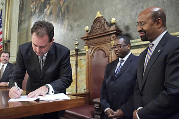 Mayor Nutter (right) looks on as House Speaker Keith McCall signs bill. (Associated Press)