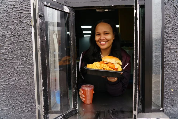 Brittany Tolliferreo in the drive-through window at her Chick-A-Boom location at 46th Street and Lancaster Avenue.