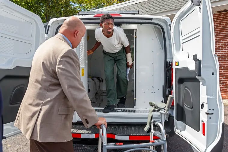 Ellijah Simmons, center, emerges from a Upper Merion Police van for his preliminary hearing at Montgomery County District Court in King of Prussia, PA on September 18, 2019.  Nyshay Hanton and Ellijah Simmons, violently carjacked a woman at the King of Prussia Mall earlier this month and then took her SUV on a joyride into West Philly, where they crashed with a SEPTA bus, injuring nine