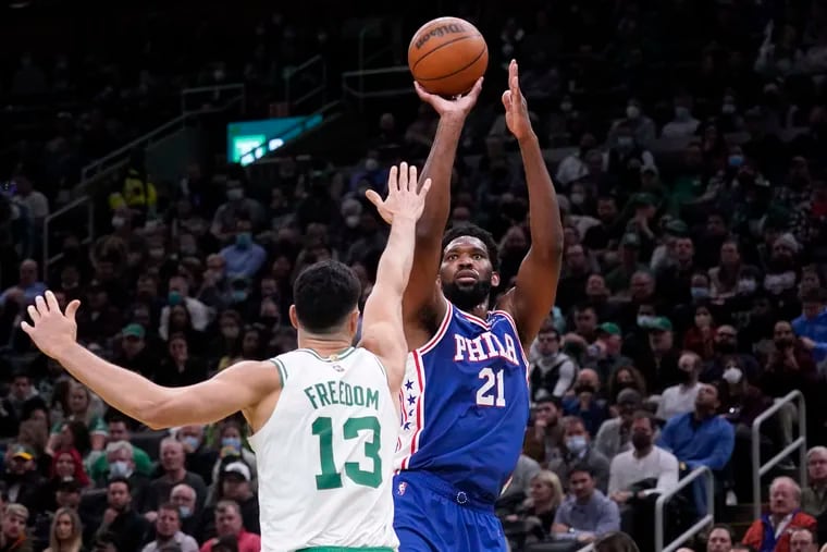 The Sixers' Joel Embiid shoots over the Celtics' Enes Freedom during the second half of Wednesday's game in Boston.