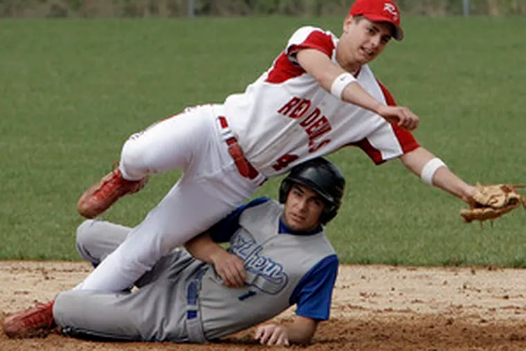 Rancocas Valley&#0039;s Eric Hacker (top) throws to first after making the force-out on Northern Burlington&#0039;s Jake DiCioccio, who slid into him trying to break up the play at second base. First-place Northern Burlington held on to win the Burlco League game, 3-2.