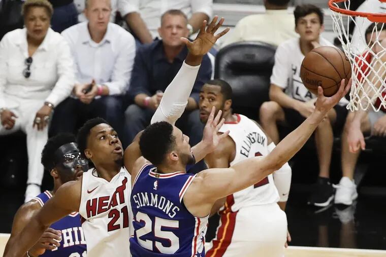 Sixers guard Ben Simmons lays up the basketball past Heat center Hassan Whiteside during Game 3.