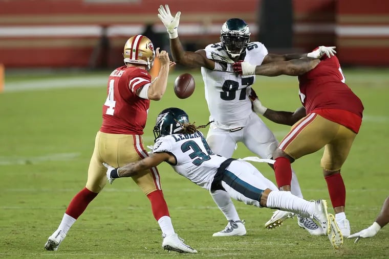 Eagles cornerback Cre'Von LeBlanc (34) forces a fumble by San Francisco 49ers quarterback Nick Mullens (4) in the fourth quarter.