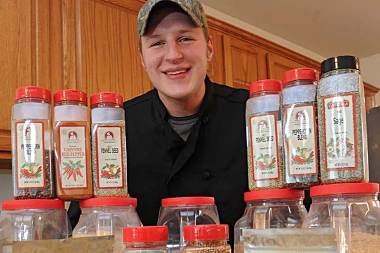 Jeremy Smith with his Hunter’s Recipe wild-game spices and rubs. CLEM MURRAY / Staff Photographer