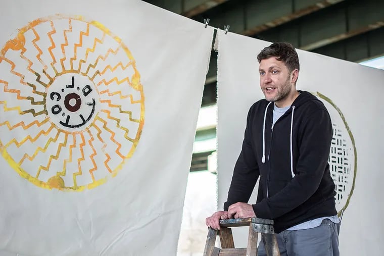 Russell Muits, a graphic designer who has created a series of prints depicting manhole covers across the United States, displays his work at the FDR Skatepark in South Philadelphia.