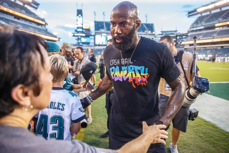 An Eagles fan reaches out to engage with Eagle safety Malcolm Jenkins, right, prior to the game against the Falcons at Lincoln Financial Field on September 6, 2018. MICHAEL BRYANT / Staff Photographer