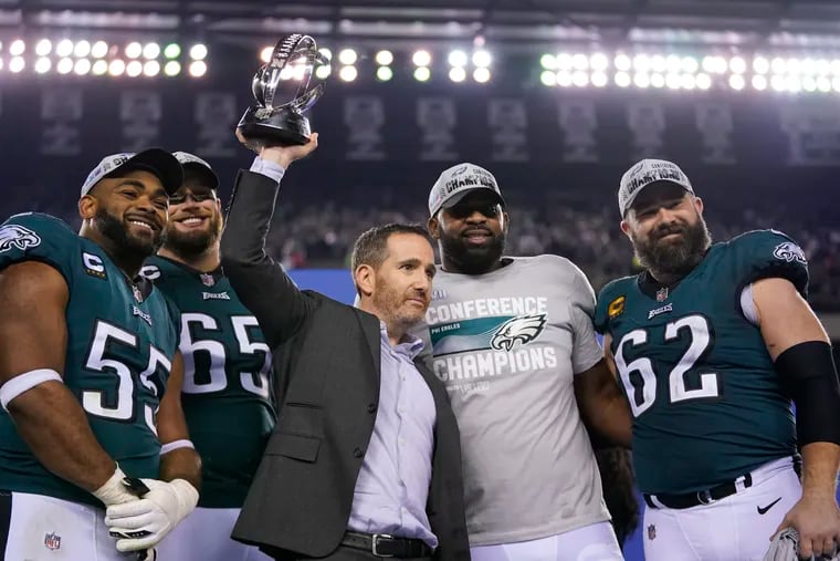 Philadelphia Eagles general manager Howie Roseman, center, stands with defensive end Brandon Graham (55) offensive tackle Lane Johnson (65), defensive tackle Fletcher Cox, and center Jason Kelce (62) after the NFC Championship NFL football game between the Philadelphia Eagles and the San Francisco 49ers on Sunday, Jan. 29, 2023, in Philadelphia. The Eagles won 31-7. (AP Photo/Matt Slocum)