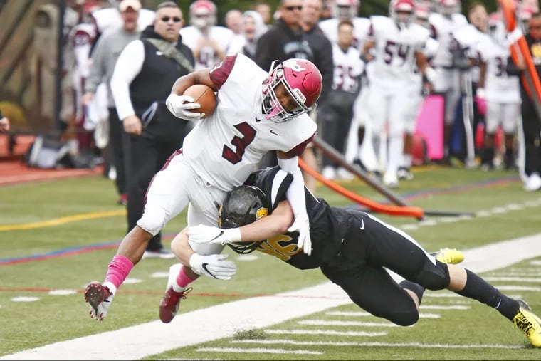 St. Joseph's Prep's Marques Mason is driven out of bounds by Archbishop Wood's Bill Cook after his 58-yard, first-quarter punt return.