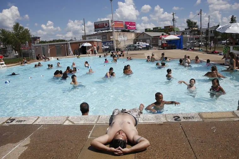 In a 2016 file photo, David Rodriguez, of North Philadelphia, relaxes on the edge of the Cione Pool as his children play in the water.