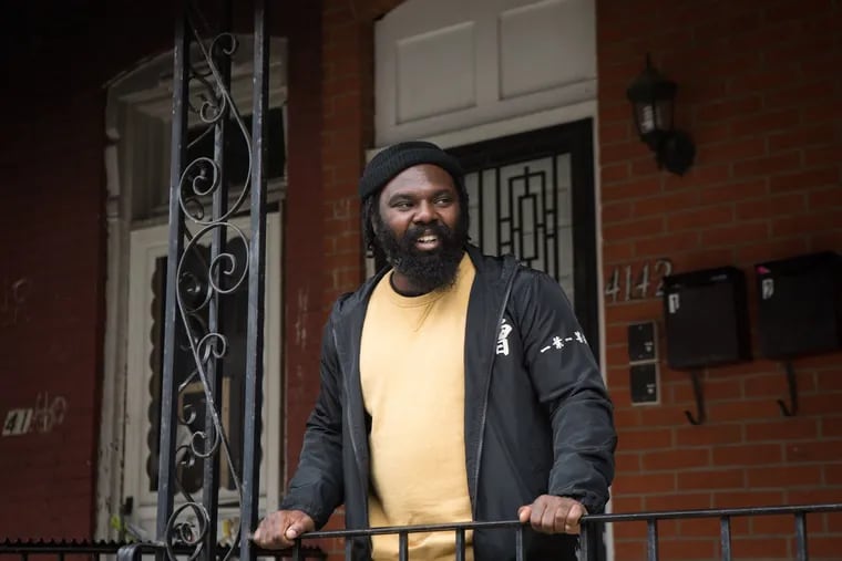 Chef Omar Tate standing in front of his West Philly home in March.