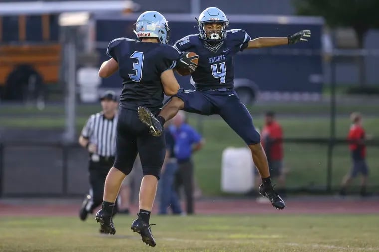 North Penn's Kenneth Grandy (4) celebrates his 69 yard TD  pass against Neshaminy with teammate Cory Keim (3) during the 2nd quarter in Lansdale.