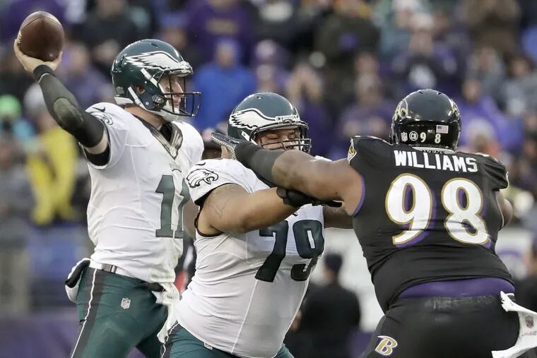 Eagles' Brandon Brooks blocks Ravens' Brandon Williams to give quarterback Carson Wentz more time to throw.