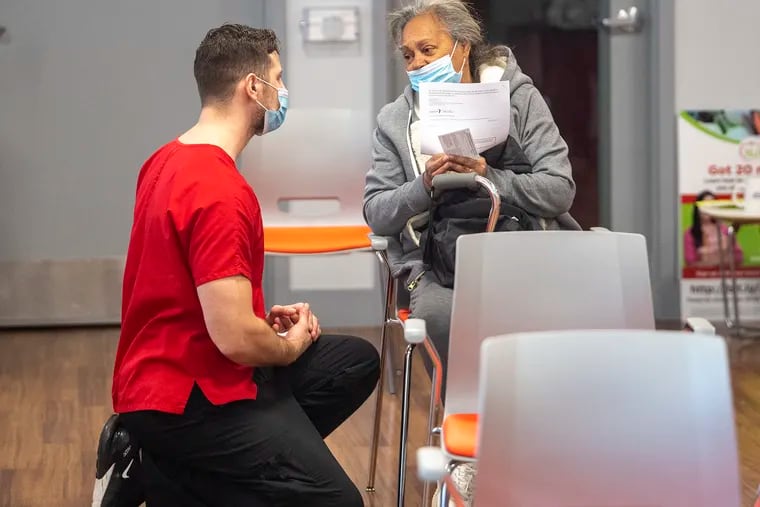 Nursing student Josh Redlich attends to Elva Gonzalez after her Johnson & Johnson COVID-19 vaccine treatment at a Rutgers Health Clinic in Camden, N.J. Friday, March 12, 2021.