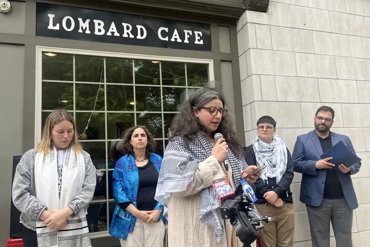 Lombard Cafe owner Jasmine Amira Taibi-Bennoui (center) addresses crowds at a news conference in front of the shop on Friday, May 17, 2024. The cafe was broken into earlier that week, one in a string of incidents Taibi-Bennoui said were sparked by her pro-Palestinian advocacy.