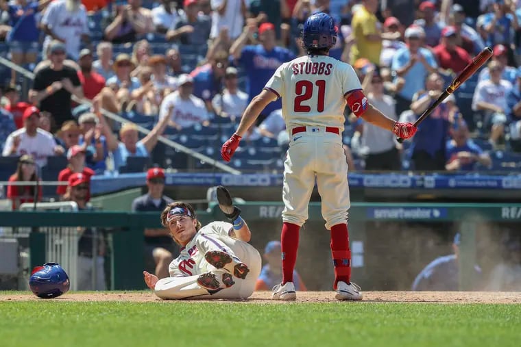 Phillies second baseman Bryson Stott reacts from the ground after unsuccessfully attempting to steal home in the fourth inning against the Mets on Saturday.