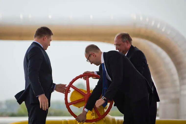 Slovakia opened a pipeline Tuesday able to deliver natural gas from the European Union to Ukraine, a major step in EU efforts to aid Kiev in its escalating dispute with Russia. Turning a valve wheel at a ceremony in Velke Kapusany, Slovakia, were (from left) Robert Fico, Slovakia's prime minister; Arseniy Yatsenyuk, Ukraine's prime minister; and Klaus-Dieter Borchardt, a European Commission official. Russia cut supplies to Ukraine in June.