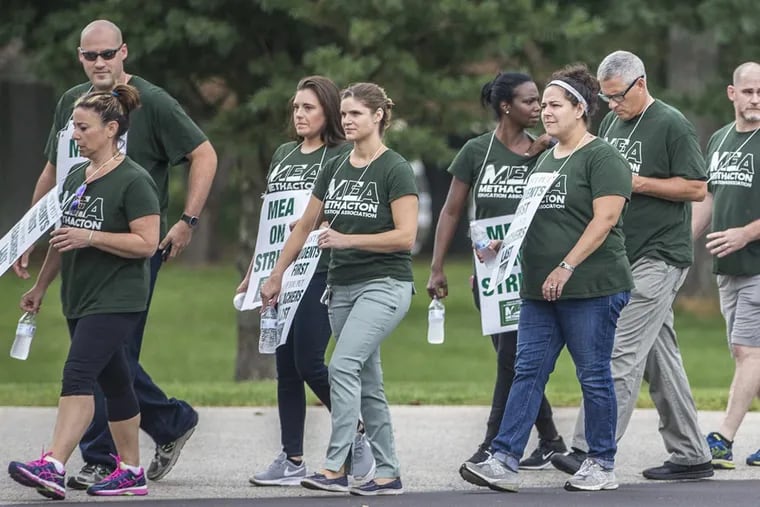 Members of the Methacton Education Association walk the picket line in front of the Methacton School DIstrict building on Monday Spetember 18, 2017.