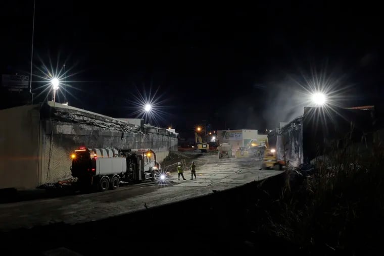 Contractors work through the night clearing debris from the I-95 Cottman Avenue off ramp after demolition was completed.