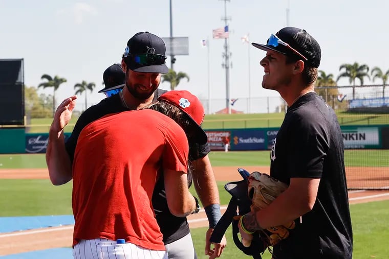 The Phillies' Brandon Marsh greets former teammates Matt Vierling and Nick Maton before a spring training game Friday in Clearwater, Fla.