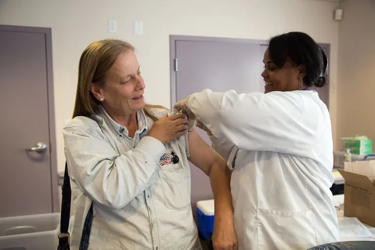 Patrica May receives her flu shot from LPN Marie Brewington at Collingswood Senior Center October 16, 2015.