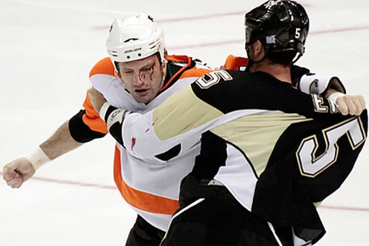 Flyers Jody Shelley and Penguins Deryk Engelland fight in the first period. (AP Photo/Keith Srakocic)