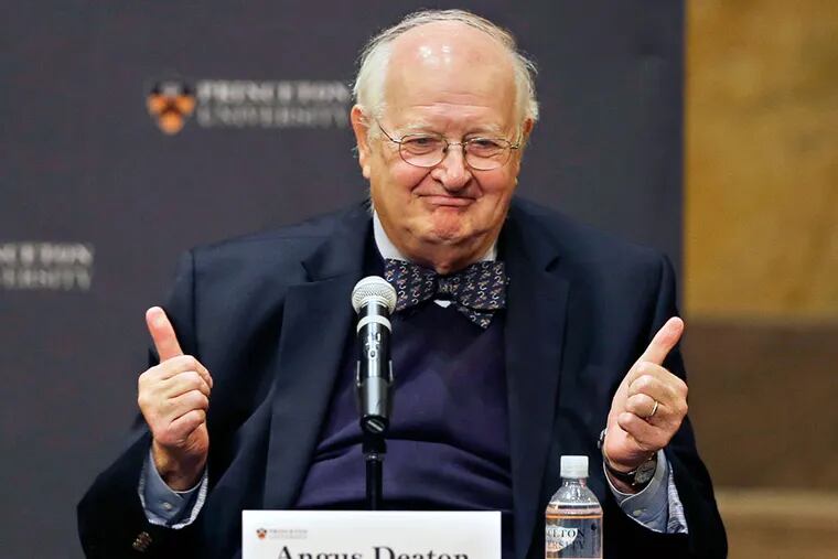 Angus Deaton gestures at a gathering at Princeton University after it was announced that he won the Nobel prize in economics for improving understanding of poverty and how people in poor countries respond to changes in economic policy, Monday, Oct. 12, 2015, in Princeton, N.J. (AP Photo/Mel Evans)