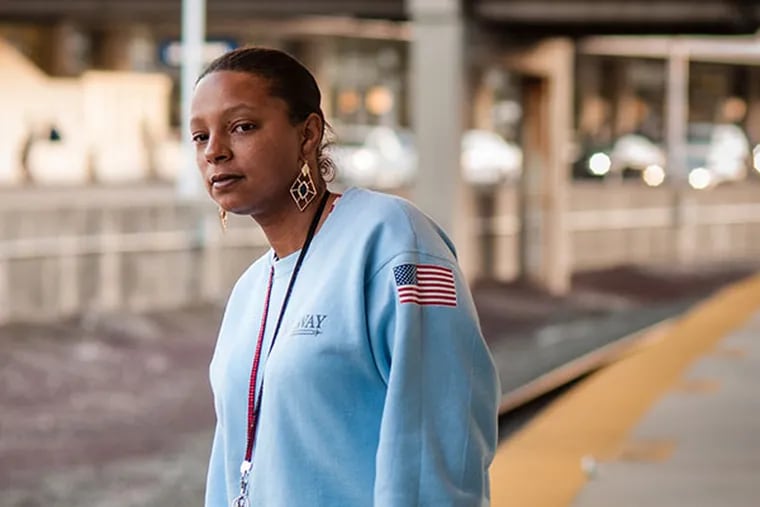 Nikishia Watson, of West Philadelphia, waits for her train home after a shift cleaning terminals at Philadelphia International Airport. She earns $8.50 an hour to support herself and her daughter while also taking classes to finish a bachelor's degree. (Matthew Hall / Staff Photographer)