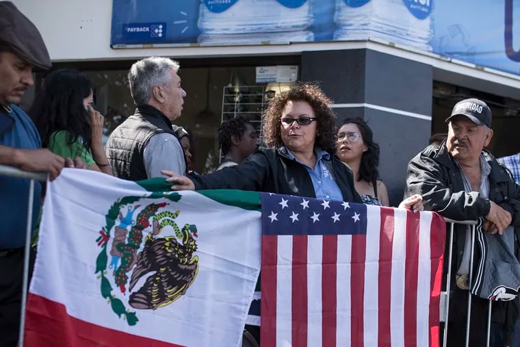 Lilia Lara, a Tijuana resident, displays the U.S. and Mexican flags at the plaza where Mexican President Andres Lopez Obrador is to hold a rally in Tijuana, Mexico, Saturday, June 8, 2019. President Trump has put on hold his plan to begin imposing tariffs on Mexico on Monday, saying the U.S. ally will take "strong measures" to reduce the flow of Central American migrants into the United States. Lara said she arrived early to get a good spot for the rally. (AP Photo/ Hans-Maximo Musielik)