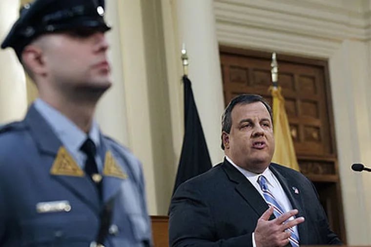 A New Jersey state trooper stands nearby in the Assembly Chamber of the Statehouse in Trenton, N.J., as Gov. Chris Christie delivers his budget address Tuesday, Feb. 21, 2012.  In his budget address, Christie proposed expanding a program that focuses on long-term social and vocational rehabilitation for former service members. (AP Photo / Mel Evans)