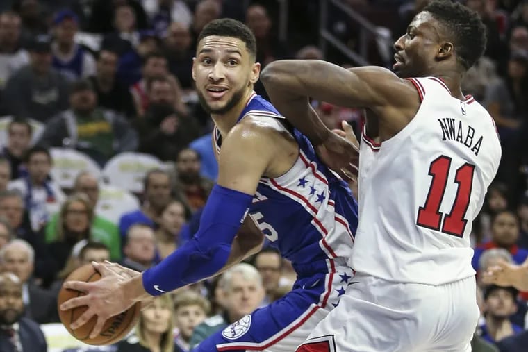 Sixers’ Ben Simmons looks to pass around Bulls’ David Nwaba during the second quarter of the Sixers’ win over the Bulls on Wednesday.