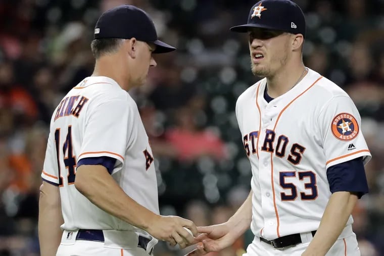 Houston Astros manager AJ Hinch (14) pulls relief pitcher Ken Giles (53) on Tuesday.