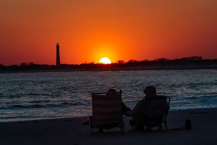 Gina and Vince Lancellotti from Hardyston New Jersey watch the sunset at Cape May Cove, Wednesday, April 12, 2023