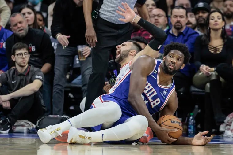 Sixers Joel Embiid scrambles on the court with the Heat’s Max Strus during the 4th quarter at the Wells Fargo Center on Monday. Sixers lose to the Heat 101-99.