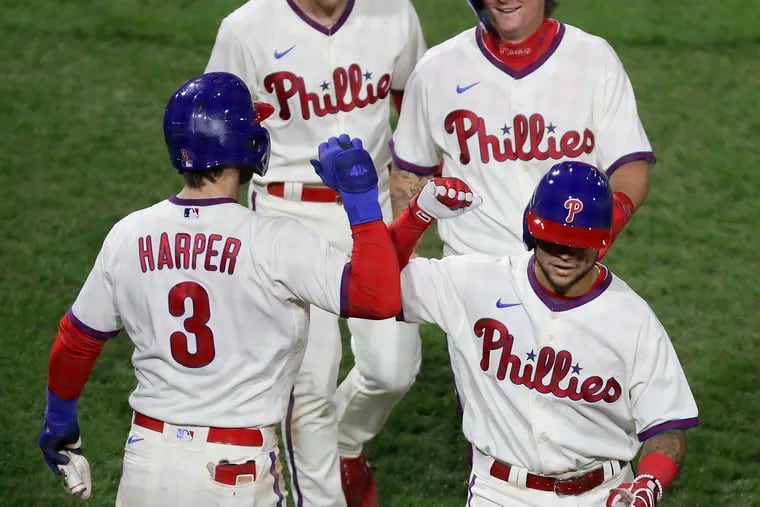 Rafael Marchán (front right) celebrates his three-run home run with teammates, from left,  Bryce Harper, Scott Kingery and Mickey Moniak on Sept. 18.
