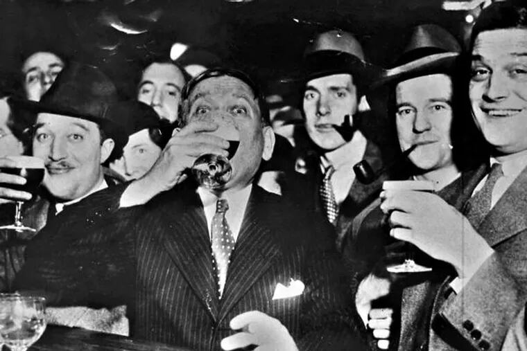 Noted columnist of the day H.L. Mencken (center) enjoys the first legal glass of beer in Baltimore, after Prohibition's demise.