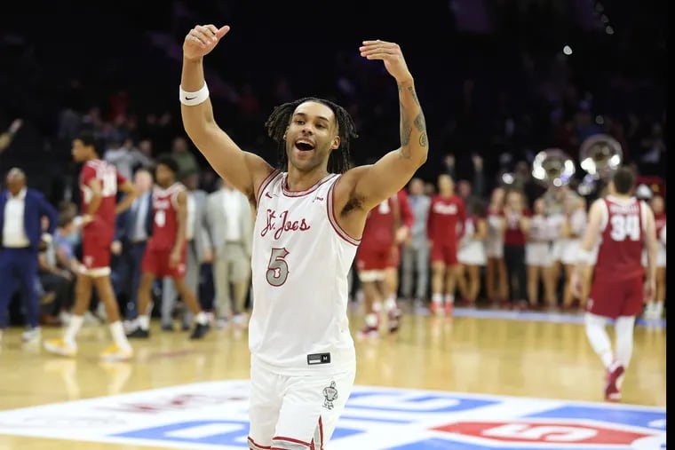 Lynn Greer III celebrates after St. Joseph's beat Temple, 74-65, to win the Big Five Classic. The Hawks are 8-2 and received a vote in the latest AP Top 25 poll.