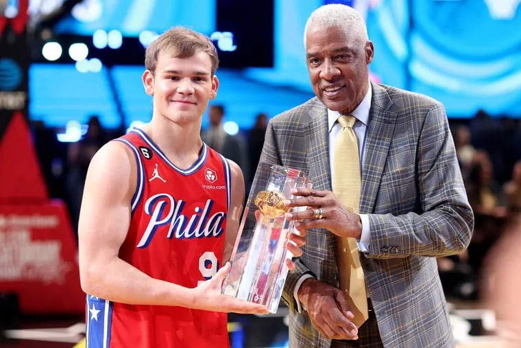 The Sixers' Mac McClung and Hall of Famer Julius Erving pose with the trophy after McClung's victory in the 2023 NBA All-Star AT&T Slam Dunk Contest at Vivint Arena on Saturday, Feb. 18, 2023, in Salt Lake City.