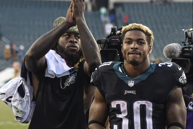 New Eagles running back Jay Ajayi (left) acknowledges the fans as he and fellow running back Corey Clement leave Lincoln Financial Field after the game against the Broncos November 5, 2017 at Lincoln Financial Field. Ajayi had one touchdown and Clement scored three touchdowns as the Eagles won 51-23. CLEM MURRAY / Staff Photographer