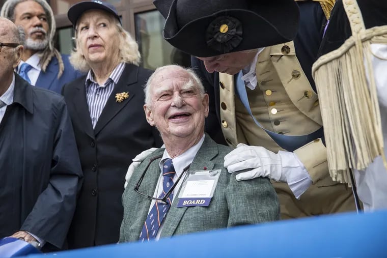 Gerry Lenfest, center,the former chairman of the Museum of the American Revolution, shares a happy moment with Dean Malissa, right, who was portraying George Washington, after Malissa had cut the opening ribbon with his saber on Wednesday April 19, 2017.