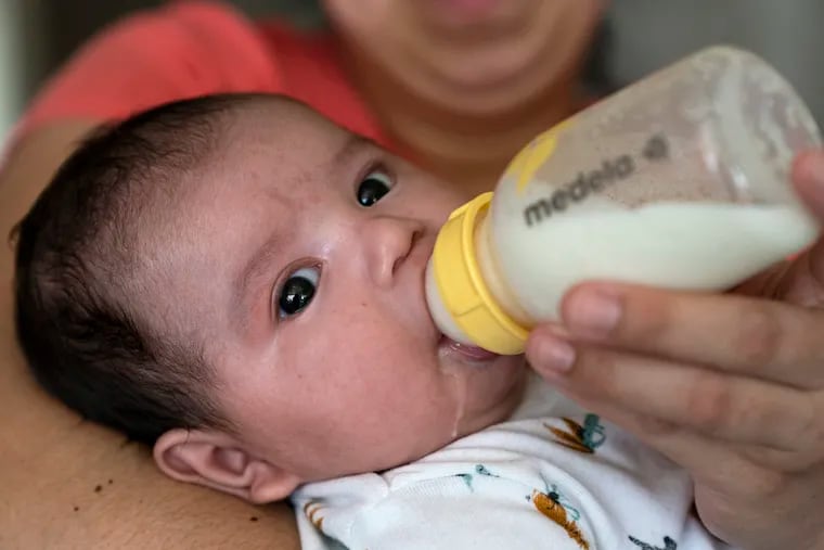 Two-month-old Jose Ismael Gálvez is fed a bottle of formula by his mother, Yury Navas, 29, from her dwindling supply of formula at their apartment in Laurel, Md.