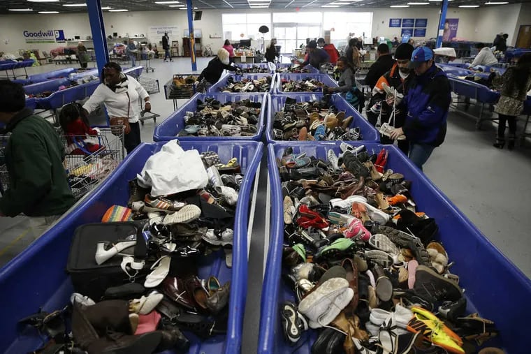 Shopping at the Goodwill outlet in Bellmawr has become competitive, with many jockeying for first shot at shoes. Donations sell for 99 cents a pound.