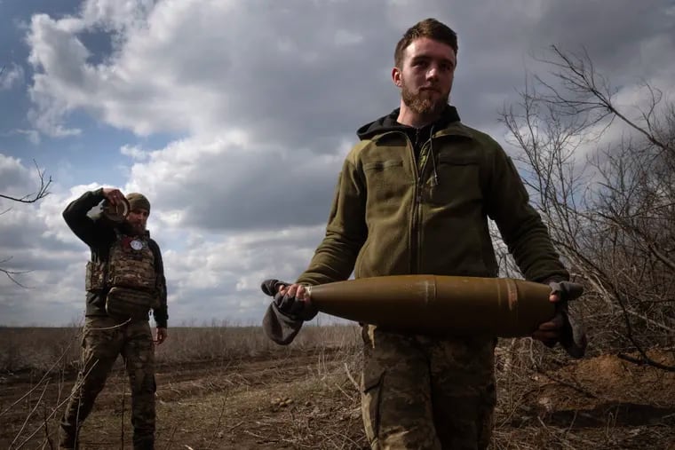 Ukrainian soldiers carry shells to fire at Russian positions on the front line, near the city of Bakhmut, in Ukraine's Donetsk region, on March 25. Approval by Congress of a $61 billion package for Ukraine means an infusion of new firepower. But the clock is ticking. Russia is using all its might to achieve its most significant gains since the invasion by a May 9 deadline.