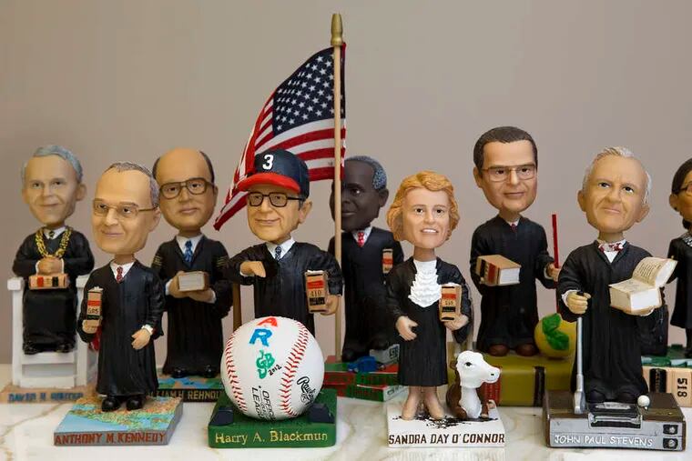 Nine of the 16 bobblehead dolls immortalizing U.S. Supereme Court justices past and present.