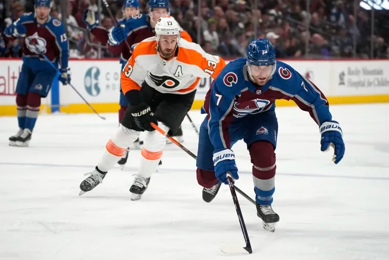 Colorado Avalanche defenseman Devon Toews, front, pursues the puck with Philadelphia Flyers center Kevin Hayes trailing during the second period of an NHL hockey game Friday, March 25, 2022, in Denver. (AP Photo/David Zalubowski)