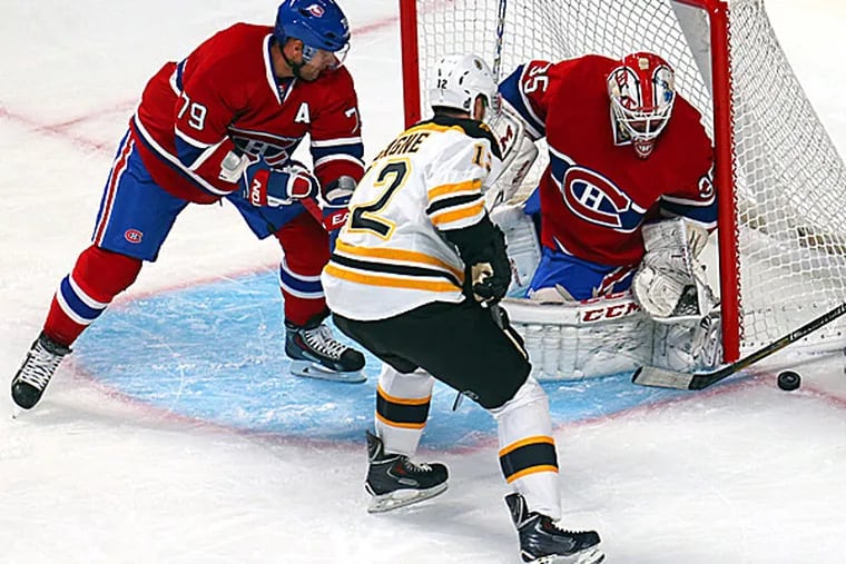 Bruins left wing Simon Gagne misses a chance to score a goal against Canadiens goalie Dustin Tokarski as defenseman Andrei Markov defends. (Jean-Yves Ahern/USA Today Sports)