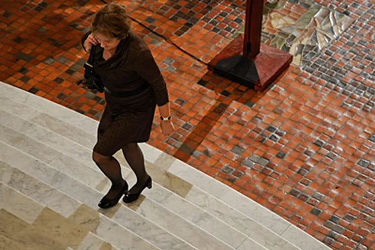 Deborah Musselman with the Pennsylvania Newspaper Assocation walks up the stairs in the State Capitol rotunda. The rough tile and steep stairs can be tricky in high heels. (Ron Tarver / Staff Photographer)